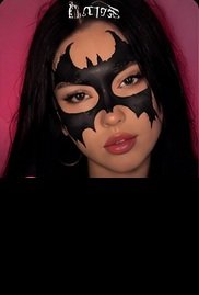 Bat girl makeup look with a black bat mask