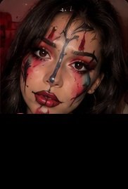 Clown makeup look with red and black face details